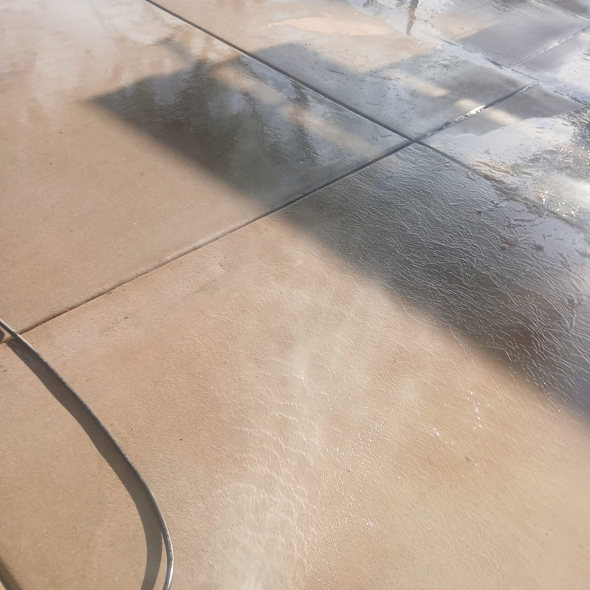 Breasy treating oil spots on a stained driveway in a Scottsdale HOA community