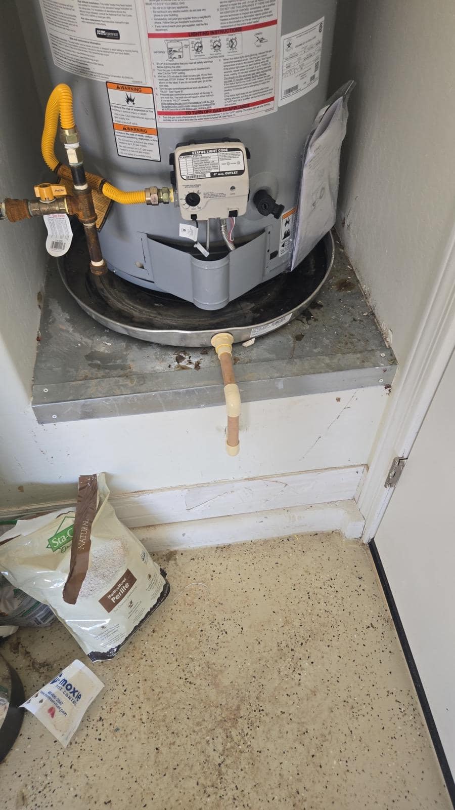 Breasy repairing a water heater affected by hard water mineral scale in a Chandler rental