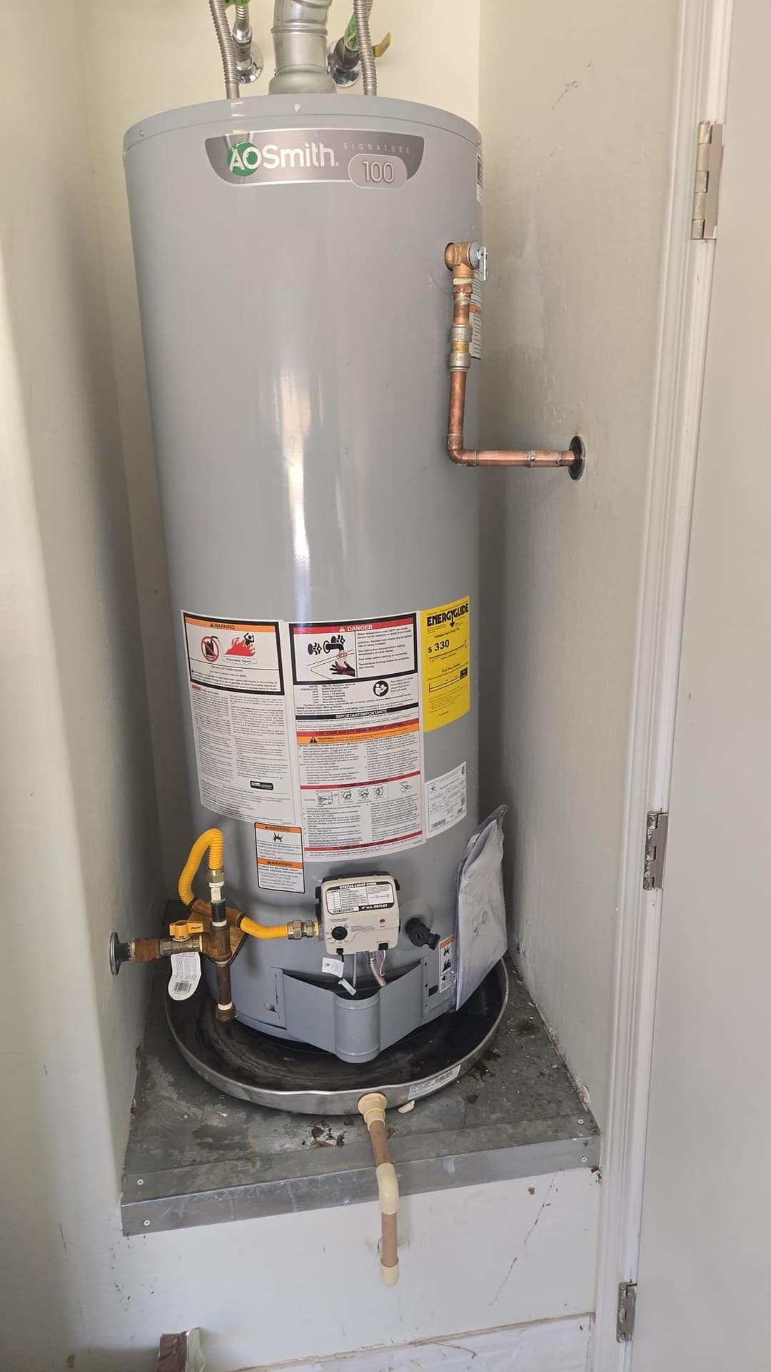 Breasy repairing a water heater affected by hard water scale in a Scottsdale rental