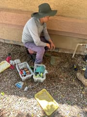 Inspecting a drip irrigation valve box at a Scottsdale rental home
