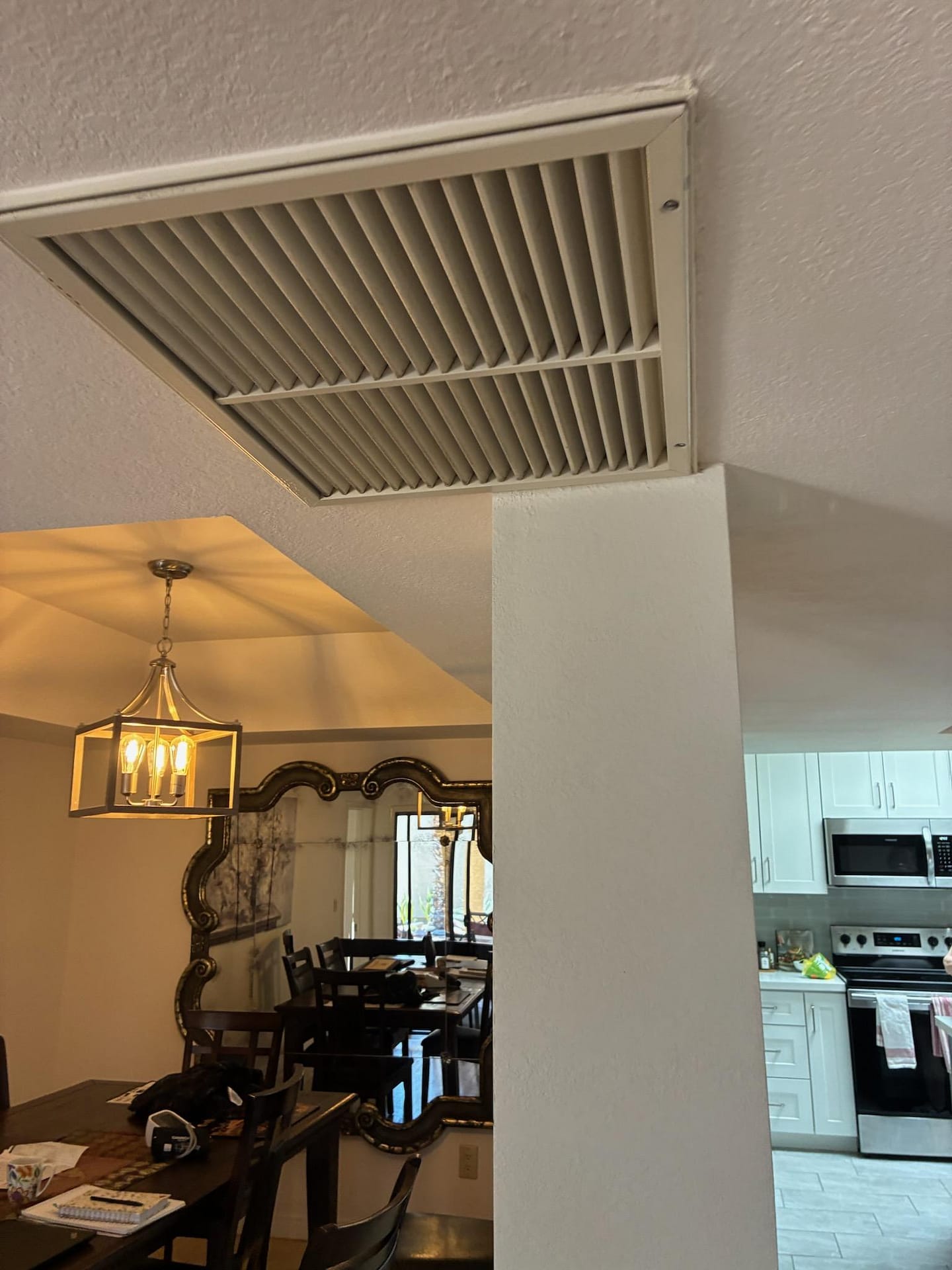Breasy replacing an HVAC filter during a Gilbert, AZ maintenance visit