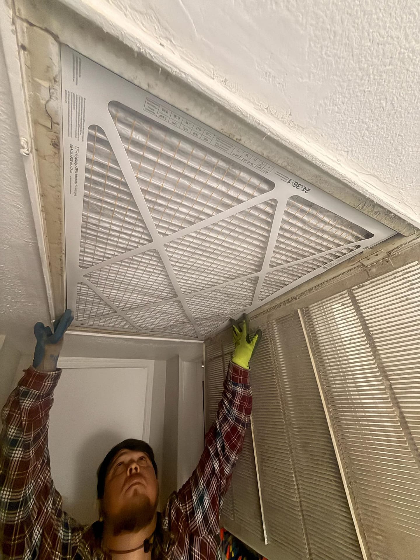 Breasy completing a rooftop AC unit check on a Scottsdale rental in summer heat